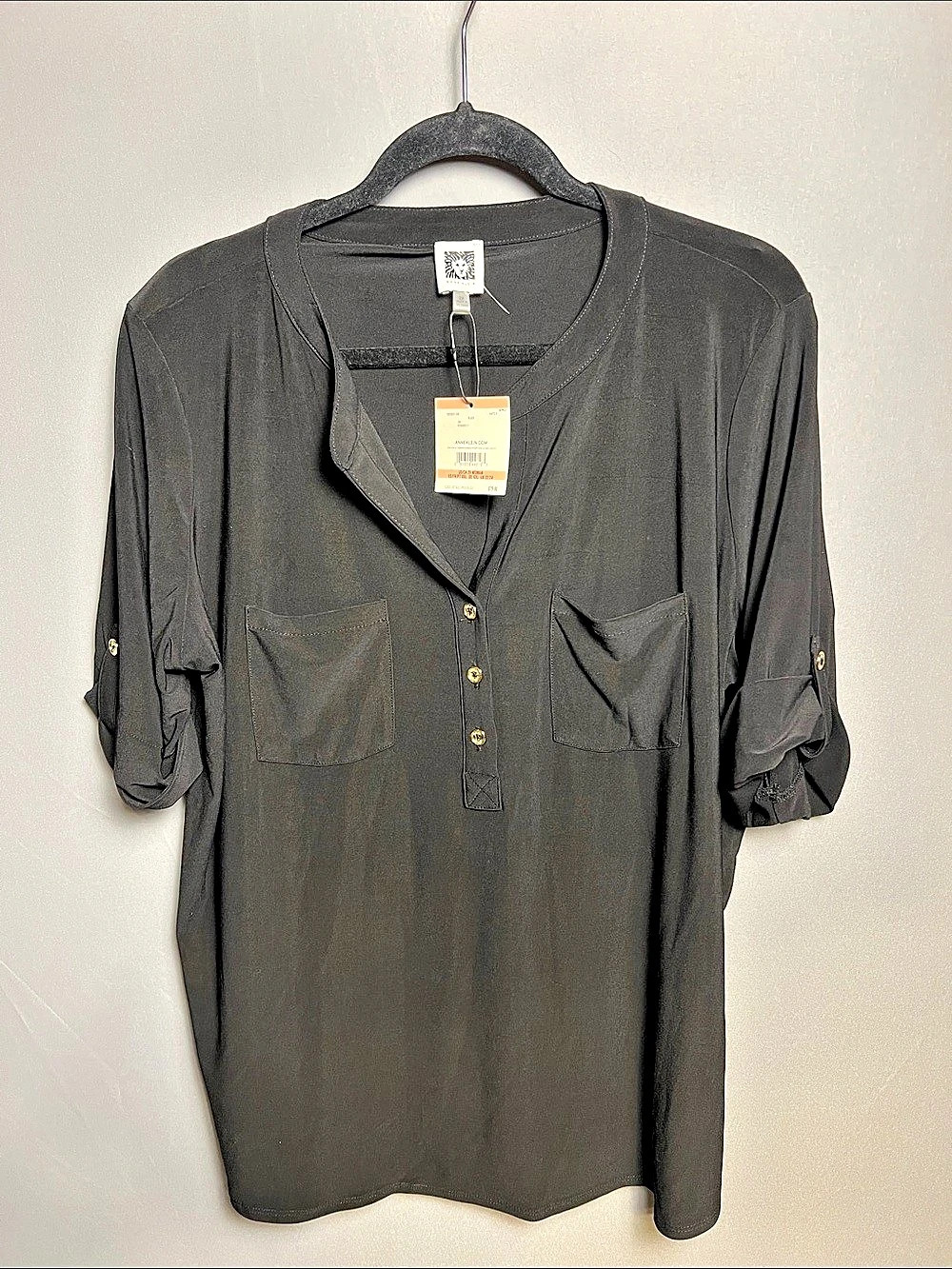 Anne Klein black V-neck tunic with polished gold-tone details and versatile roll